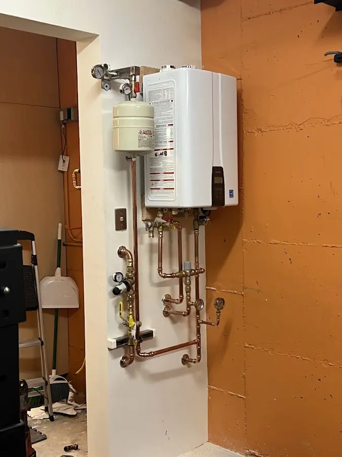 Plumbing technician inspecting water heater connections in Arizona City